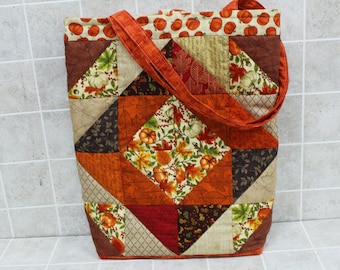 Handbag or tote for the fall, shorter handles, small flap and button closer, hand quilted,cotton liner with pockets on both sides