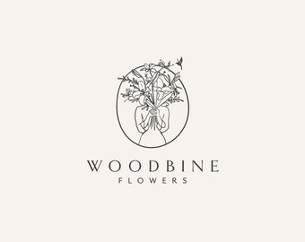 May include: Black and white line art logo design for a flower shop called "Woodbine Flowers". The logo features a stylized image of a person holding a bouquet of flowers in front of their face. The text "Woodbine Flowers" is below the image.