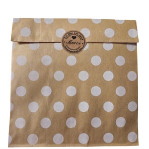 May include: A brown paper bag with white polka dots. The bag has a sticker that says "Fait Main Avec Amour" and "Merci" with a heart symbol.