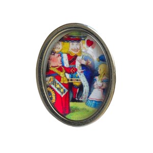 May include: A silver oval-shaped pin with a glass dome featuring a colorful illustration of the Queen of Hearts, the King of Hearts, and Alice from Alice in Wonderland.