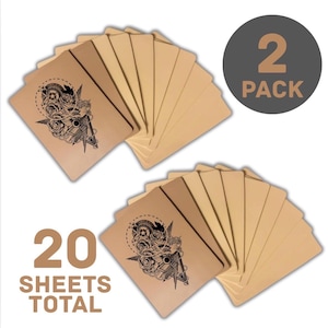 May include: Two packs of tattoo transfer sheets. Each pack contains a stack of blank sheets and one sheet with a black tattoo design. The design features a detailed illustration with roses, a compass, and other elements. The text reads "20 SHEETS TOTAL".