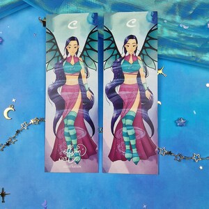 May include: Two printed bookmarks featuring a cartoon character with purple hair, a pink and blue outfit, and blue wings. The character is standing on a swirling background. The text "ellyon art" and "ILLUSTRATION" are printed on the bottom of the bookmarks.
