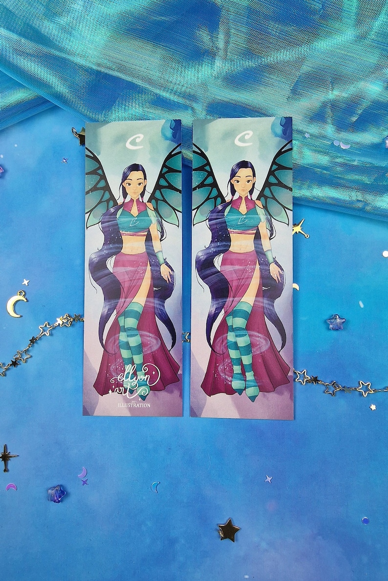May include: Two printed bookmarks featuring a cartoon character with purple hair, a pink and blue outfit, and blue wings. The character is standing on a swirling background. The text "ellyon art" and "ILLUSTRATION" are printed on the bottom of the bookmarks.