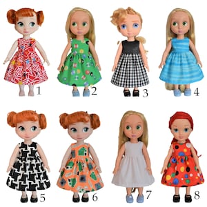 May include: Eight different doll dresses in various colors and patterns, including red, green, black, white, and blue. The dresses are all sleeveless and have a full skirt. The dolls are not included.