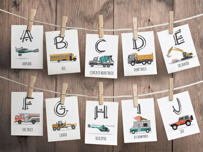 May include: A set of 10 flashcards featuring the alphabet with illustrations of vehicles. Each card has a letter, a vehicle illustration, and the name of the vehicle. The vehicles include an airplane, bus, concrete mixer truck, dump truck, excavator, fire truck, grader, helicopter, ice cream truck, and jeep.