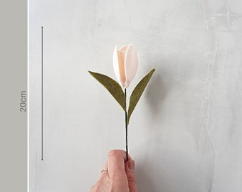 May include: A pale pink felt tulip flower with two dark green felt leaves on a thin stem. A vertical line graphic with the text 20cm indicates the height of the flower. The text Mini Flower Selection is printed at the bottom of the image.