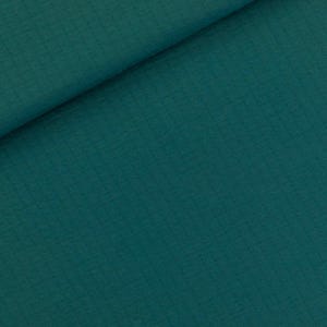 May include: Close-up of folded teal fabric. The material has a subtle textured pattern, with diagonal lines creating visual interest. The colour is a deep, saturated teal, with a slight sheen.