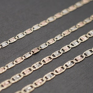 May include: Four gold chains with a patterned design. The chains are made of different colored gold, including yellow, white, and rose gold.