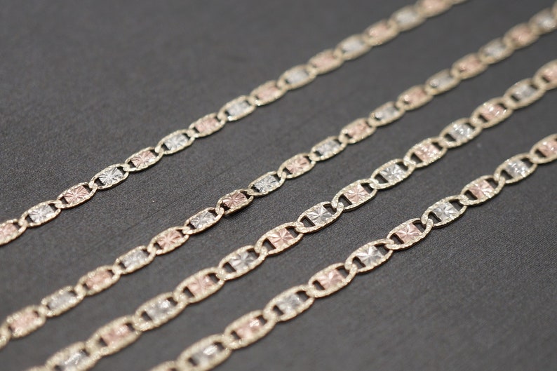 May include: Four gold chains with a patterned design. The chains are made of different colored gold, including yellow, white, and rose gold.