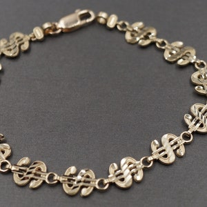 Bracciale in oro giallo massiccio 10K con simbolo del dollaro e taglio diamante da 7,6 mm. 7 pollici
