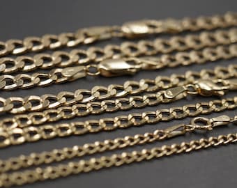 May include: A close-up of several gold chains of different lengths and widths. The chains are arranged in a staggered pattern, with the thickest chain at the bottom and the thinnest chain at the top.