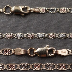 May include: Three gold chains with a 10K stamp. The chains are made of three different colors of gold: yellow, white, and rose. The chains are linked together in a pattern of small squares.
