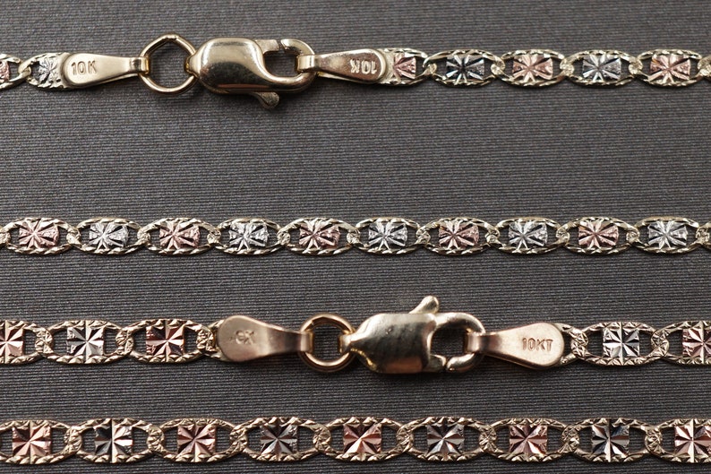 May include: Three gold chains with a 10K stamp. The chains are made of three different colors of gold: yellow, white, and rose. The chains are linked together in a pattern of small squares.