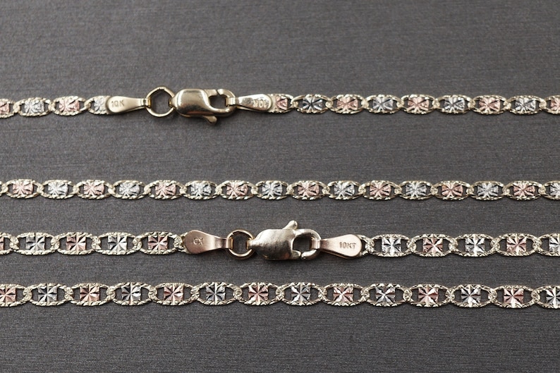 May include: Three gold chains with a patterned design. The chains are made of 10K gold and have a lobster clasp.