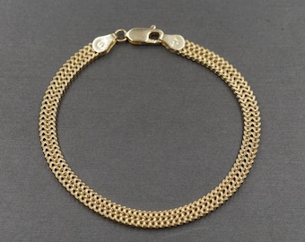 May include: A gold chain bracelet with a woven design.