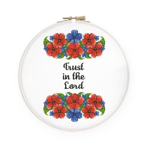 May include: Embroidered hoop art with red and blue flowers and the text "Trust in the Lord".