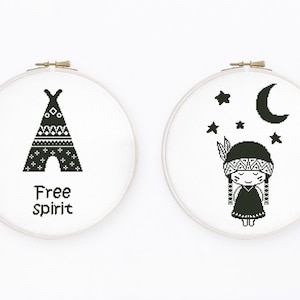 May include: Two round embroidery hoops with black and white cross-stitch designs. One features a teepee with the words "Free spirit." The other depicts a Native American girl with stars and a crescent moon.