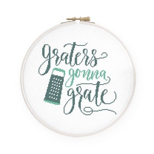 May include: A white embroidery hoop with a green and black grater and the text "Graters gonna grate" in black cursive lettering.
