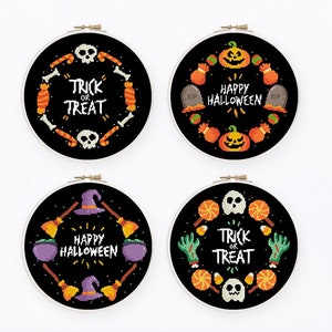 May include: Four black cross-stitch hoops with Halloween designs. Each hoop features a circular arrangement of Halloween icons like pumpkins, skulls, and sweets, with phrases such as "Trick or Treat" and "Happy Halloween".