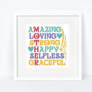 May include: White framed cross stitch pattern with the words "AMAZING LOVING STRONG HAPPY SELFLESS GRACEFUL" in colourful letters.