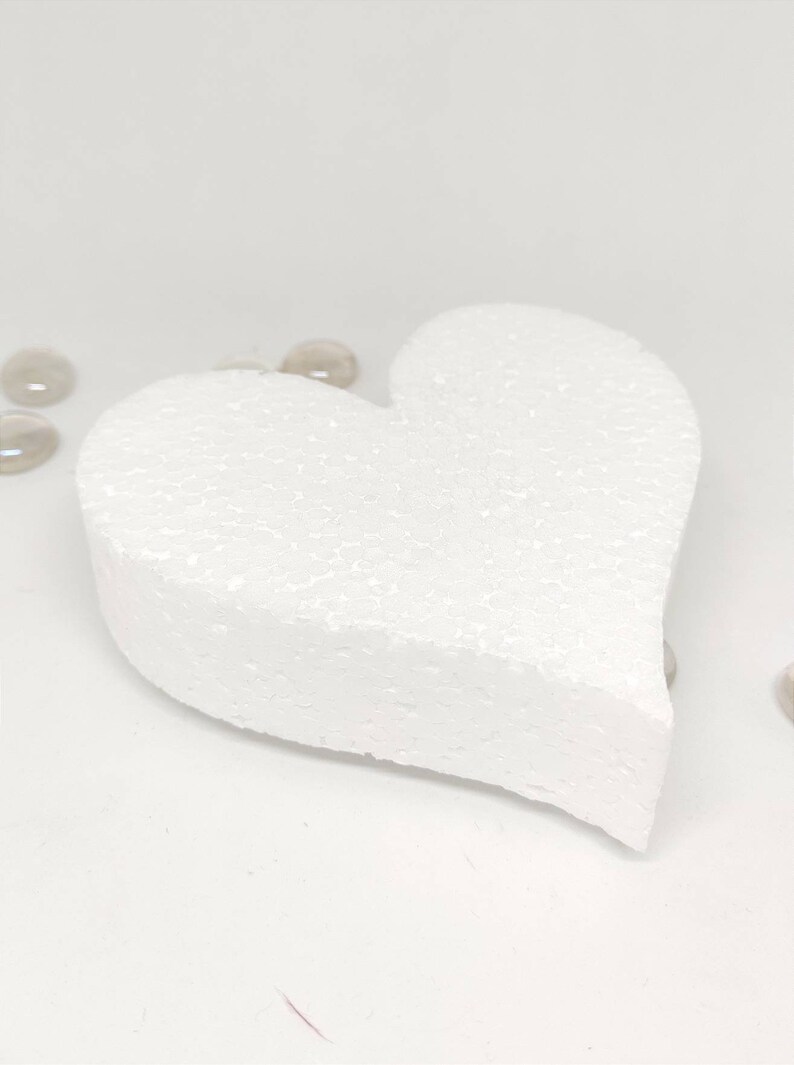 May include: A white foam heart shape, perfect for crafting projects. The heart is smooth and has a slightly textured surface.