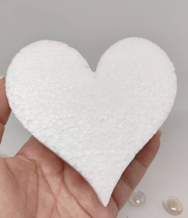 May include: A white foam heart shape, perfect for crafting projects. The heart is smooth and has a slightly textured surface.