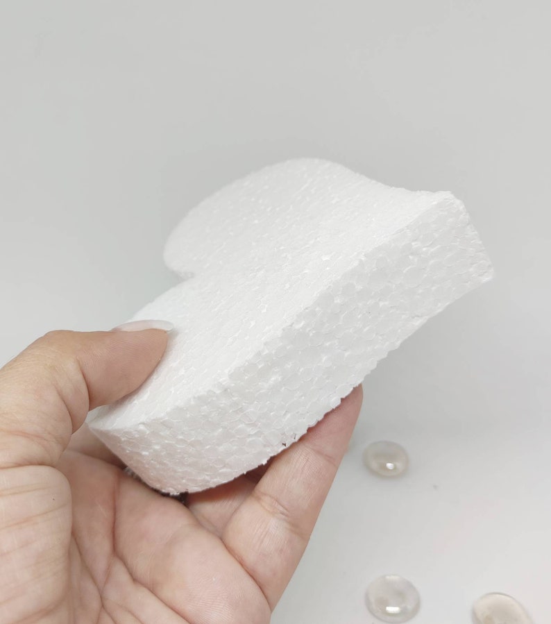 May include: A white styrofoam heart shape, perfect for crafting projects. The heart is smooth and has a slightly textured surface.