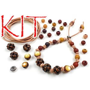 May include: A kit for making a bracelet with brown leather cord, brown and red beads, and a silver clasp. The kit includes a variety of beads in different shapes and sizes.