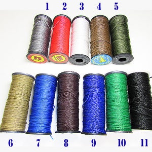 May include: Eleven spools of waxed thread in various colors, including gray, red, white, brown, green, beige, blue, dark brown, light blue, dark green, and black. The spools are numbered 1 through 11.