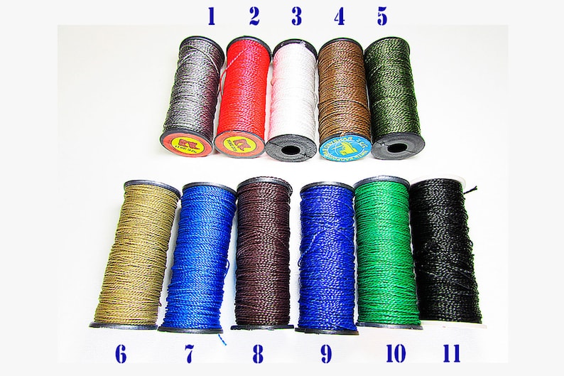 May include: Eleven spools of waxed thread in various colors, including gray, red, white, brown, green, gold, blue, dark brown, black, and dark green. The spools are numbered 1 through 11.