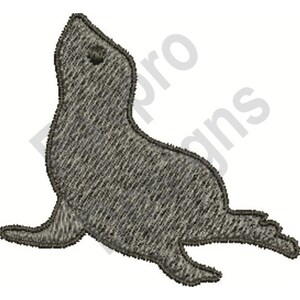 May include: A grey seal with a textured surface, looking up with its mouth closed. The seal is lying on its belly with its flippers extended.