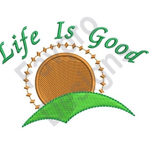 May include: Embroidered design with a green hill, a brown sun with a green circle around it, and the text "Life Is Good" in green.
