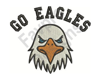 May include: Go Eagles! Embroidery design featuring a cartoon eagle head with a fierce expression. The eagle has white feathers, a yellow beak, and blue eyes.