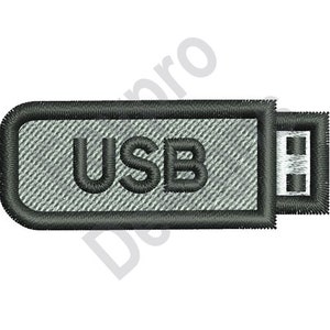 May include: A grey USB drive with a black border and the word "USB" printed on it.