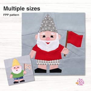 May include: A foundation paper piecing pattern featuring two gnome designs. The larger gnome wears a grey polka dot hat, red shirt, and checkered shorts, holding a red flag. The smaller gnome has a yellow hat, green shirt, and blue shorts.