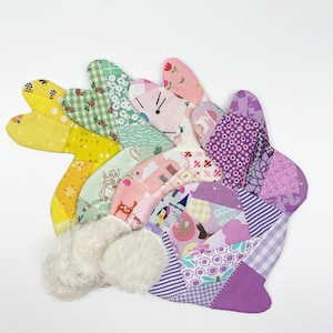 bunny shaped placemat and coaster sewing pattern, sewn with fabric scraps in pink , yellow, purple and green with a fake fur little tail.