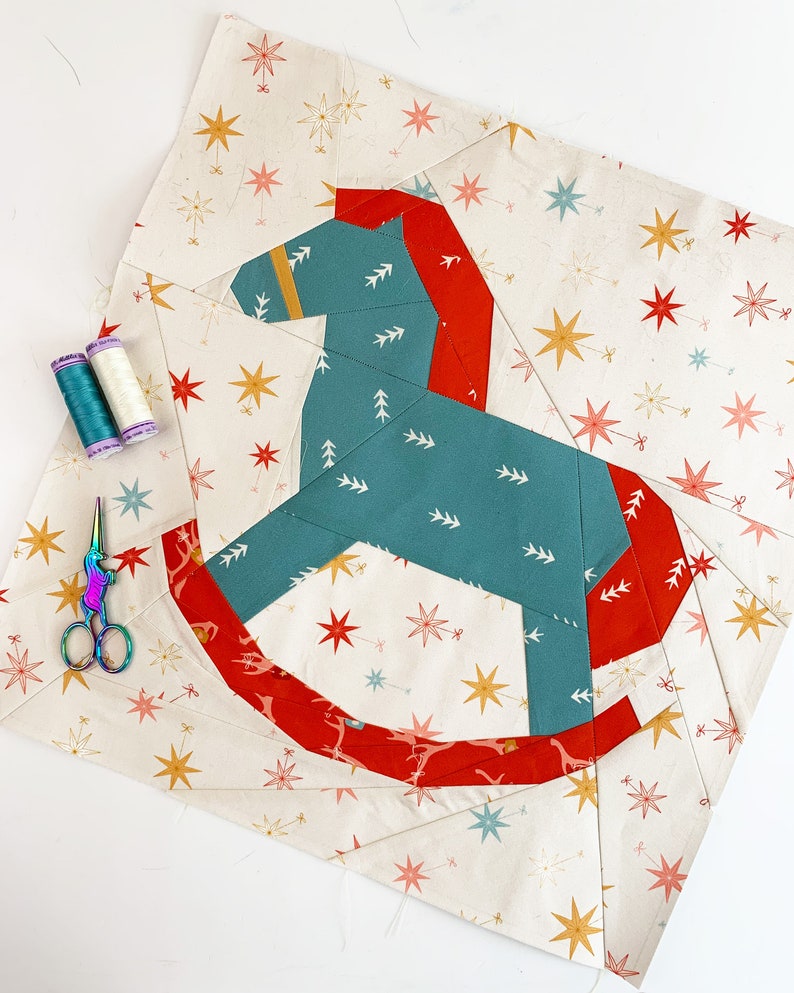 Rocking horse quilt block pattern, blue and red rocking horse on multicolored background