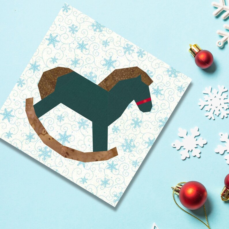 Rocking horse quilt block pattern, green and brown rocking horse on white and blue background