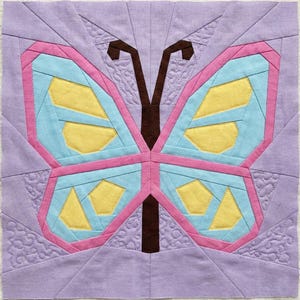 Butterfly quilt block pattern in 4 different sizes, perfect scrap buster, shown with sewing utensils