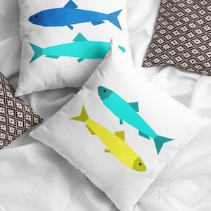 Sardines Quilt block pattern, used to make two super sunny summer pillows with two sardines each. The colors are blue and turquoise with bright yellow.