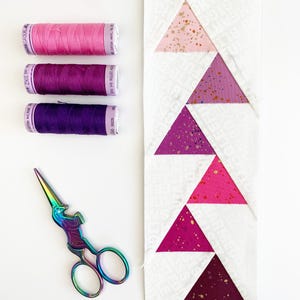 offset Flying geese quilt blocks in pinks, blues and yellows. These Jumping flying geese are perfect for quilt borders, and to enhance any quilt block.