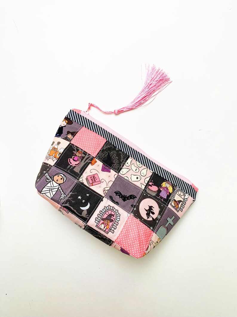 Patchwork zipper pouch sewing pattern in three sizes, the pouches are patchwork pouches, sewn with small fabric squares and contrast binding along the zipper with matching zippers. Zipper pouch sewing pattern