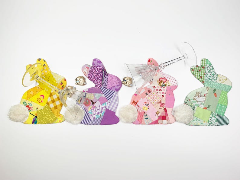 bunny shaped placemat and coaster sewing pattern, sewn with fabric scraps in pink , yellow, purple and green with a fake fur little tail.