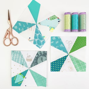Kaleidoscope quilt blocks in turquoise and white with sewing utensils