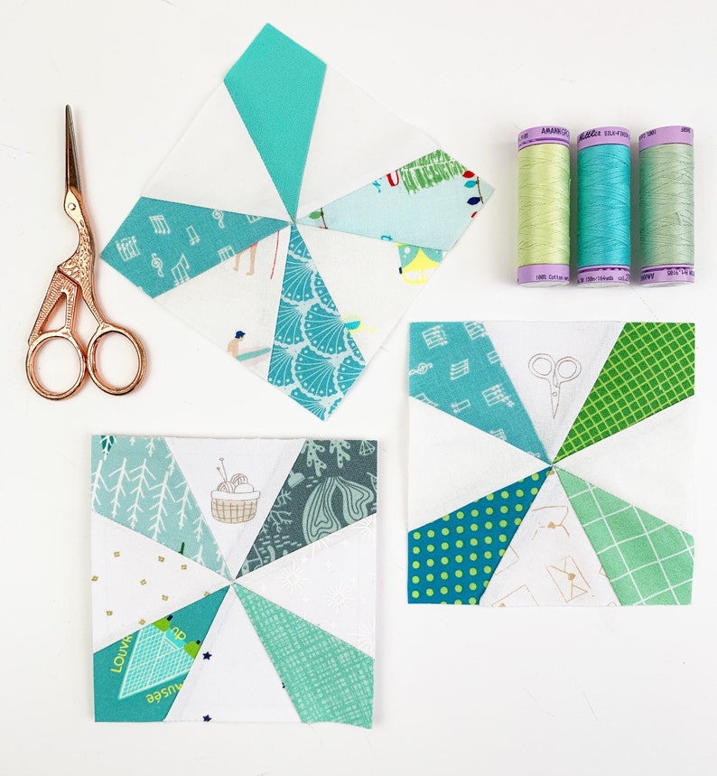 Kaleidoscope quilt blocks in turquoise and white with sewing utensils