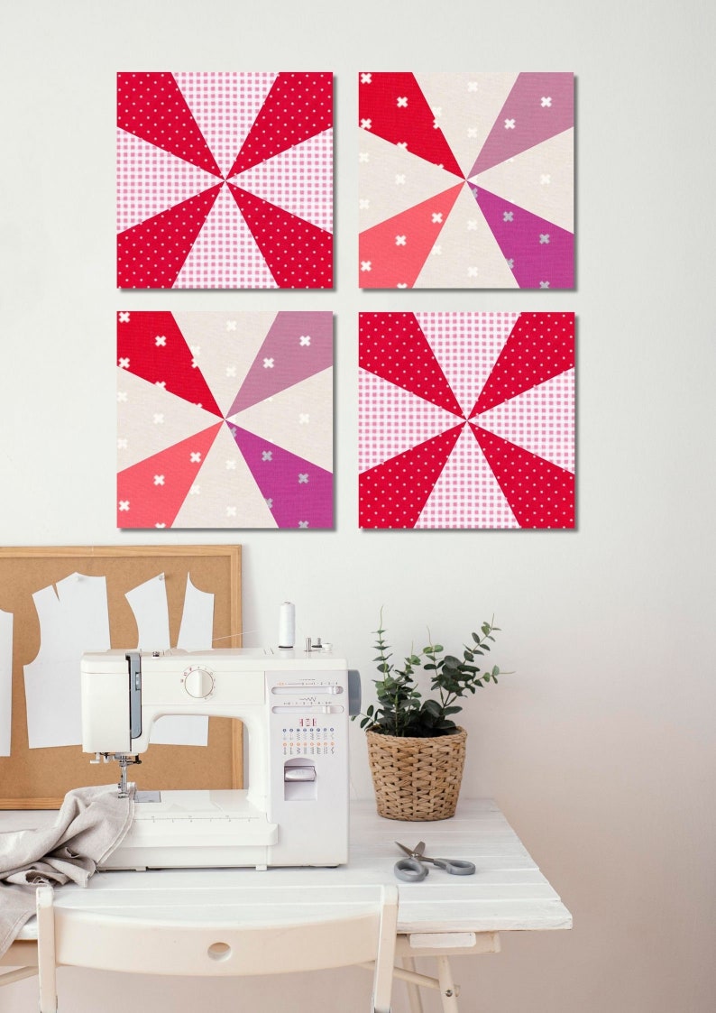 4 Kaleidoscope quilt blocks hanging on the wall on top of a sewing machine