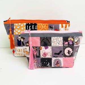 Patchwork zipper pouch sewing pattern in three sizes, the pouches are patchwork pouches, sewn with small fabric squares and contrast binding along the zipper with matching zippers. Zipper pouch sewing pattern
