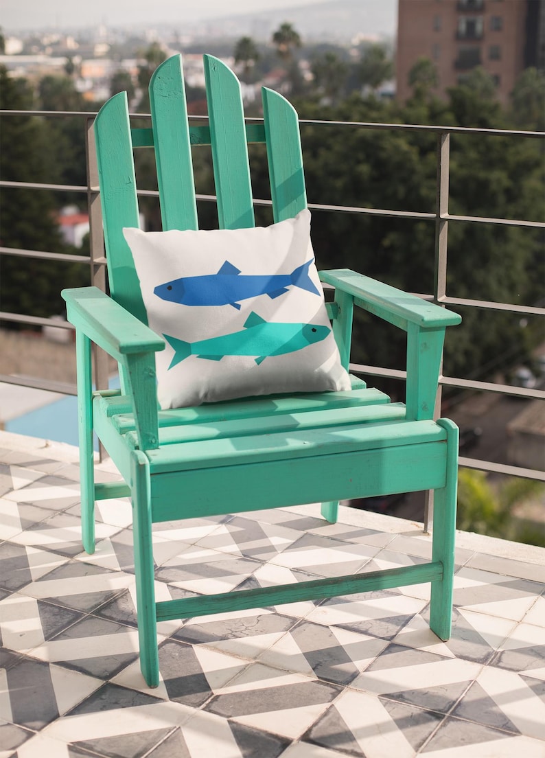 Sardines Quilt block pattern, used to make a super sunny summer pillow with two sardines. The colors are blue and turquoise on a bright sunny turquoise colored Adirondack chair.