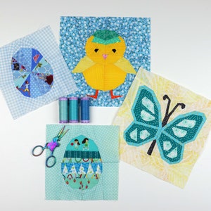 May include: Four fabric squares with different designs for a quilt. The squares feature a blue and white checkered egg, a yellow chick with a blue hat, a blue butterfly, and a blue and green egg with a pattern of girls playing.