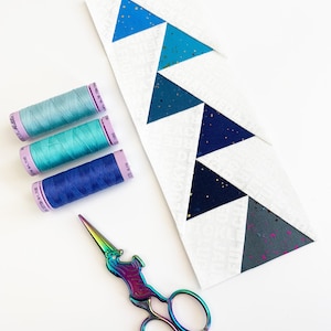 offset Flying geese quilt blocks in pinks, blues and yellows. These Jumping flying geese are perfect for quilt borders, and to enhance any quilt block.
